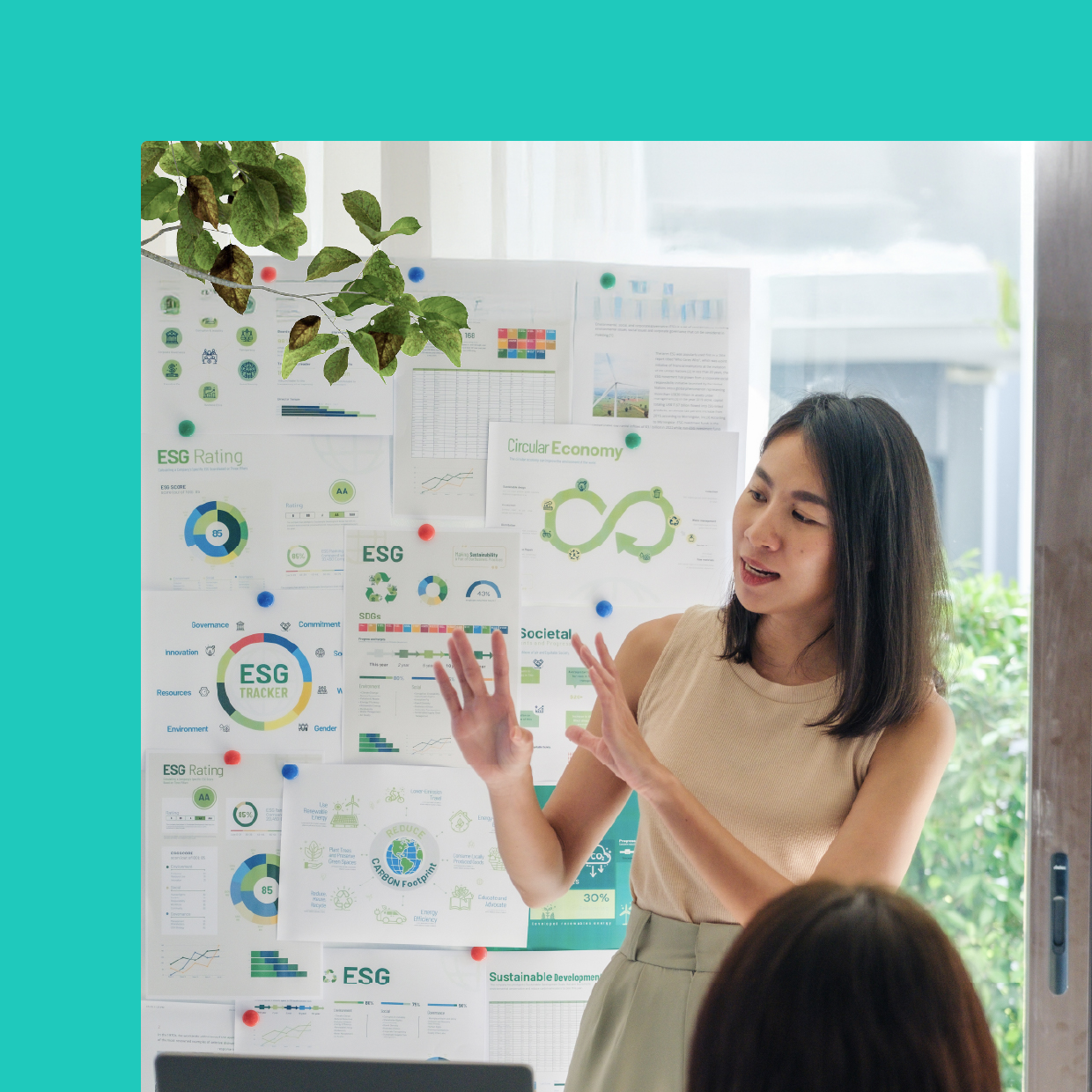 A businesswoman interactively presenting data visualizations and charts on an information board in an office.