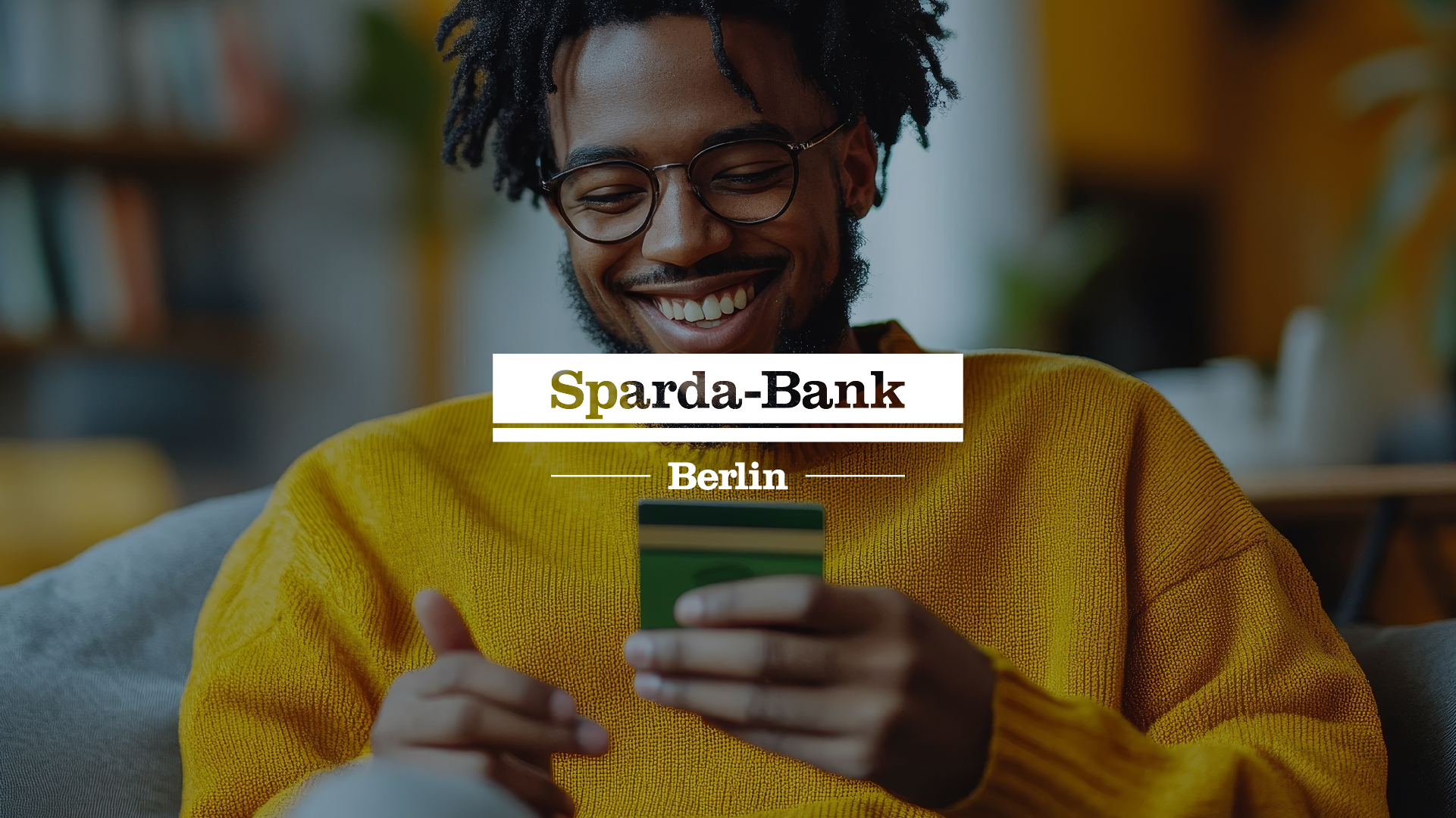 Cover of a success case with Sparda-Bank Berlin, featuring a cheerful young man with dreadlocks wearing a yellow sweater, looking at a smartphone.